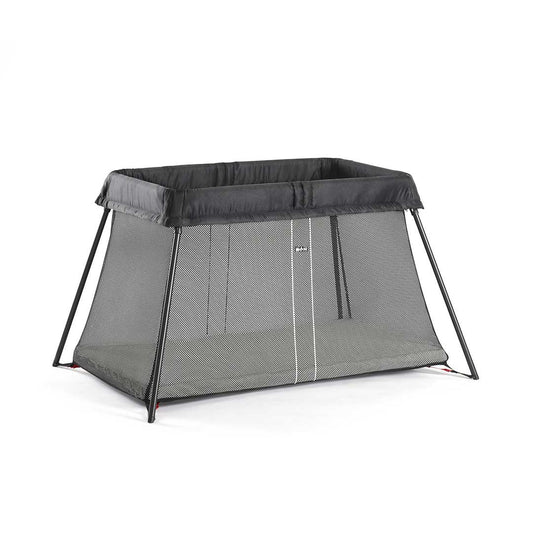 BabyBjörn Travel Cot Light in black, lightweight and easy-to-fold portable crib with breathable mesh sides, available for rental