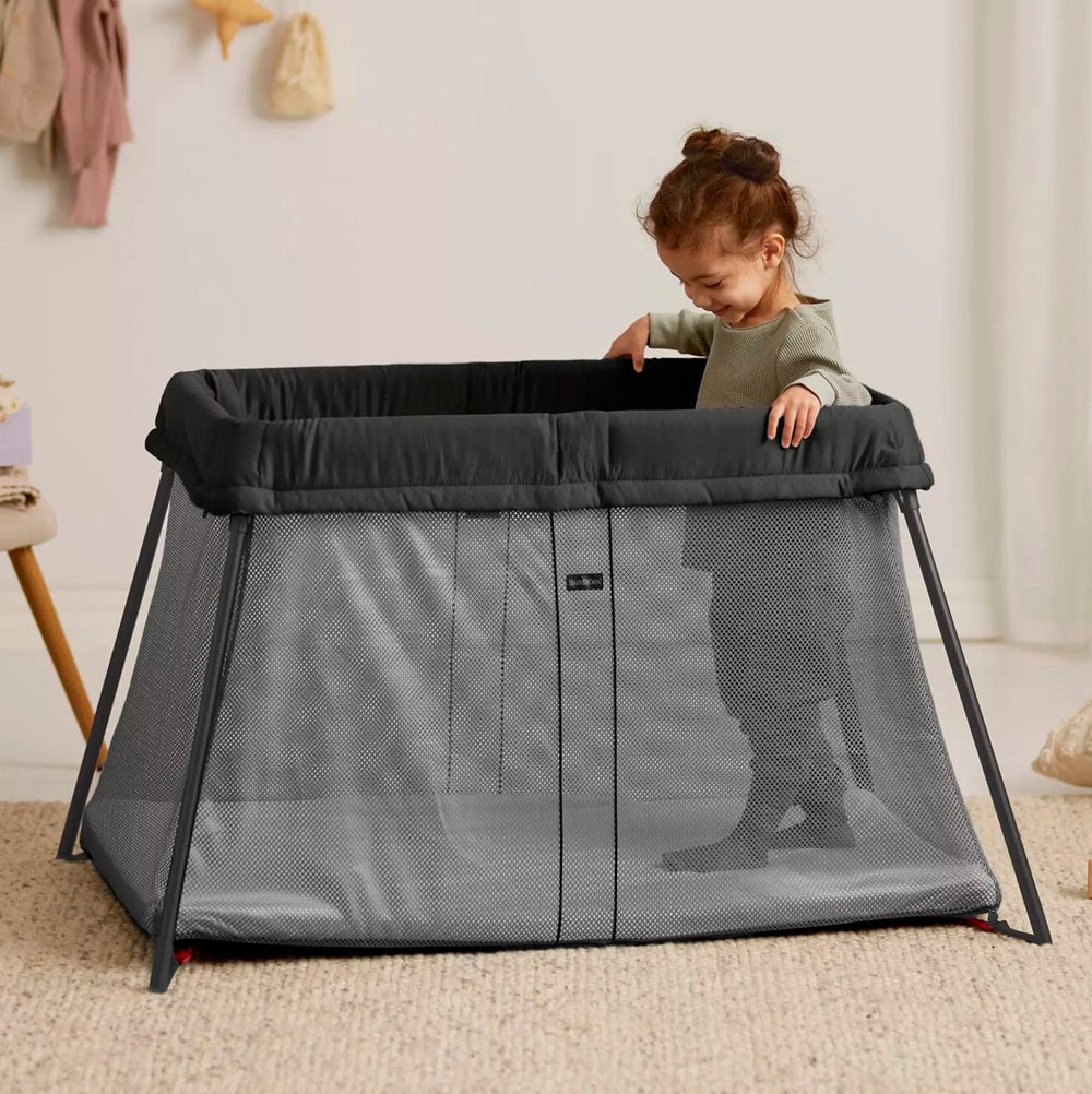 BabyBjörn Travel Cot Light in black, lightweight and easy-to-fold portable crib with breathable mesh sides, available for rental