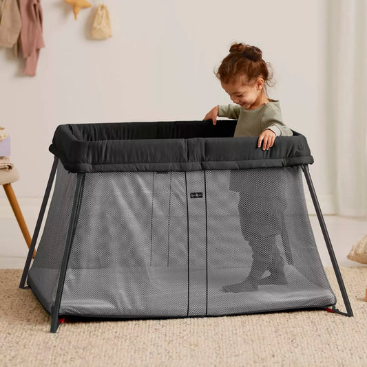 BabyBjörn Travel Cot Light in black, lightweight and easy-to-fold portable crib with breathable mesh sides, available for rental