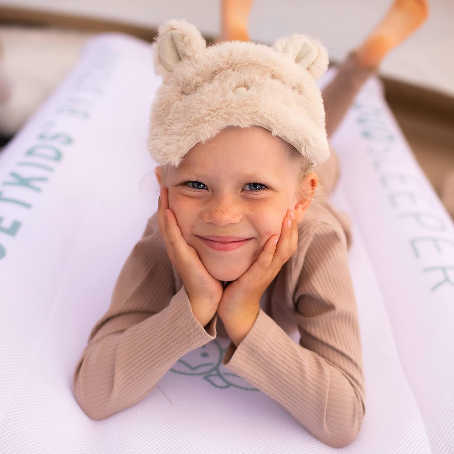 Toddler lying comfortably on Stokke CloudSleeper travel bed – portable inflatable mattress hire for children from Thursday’s Child