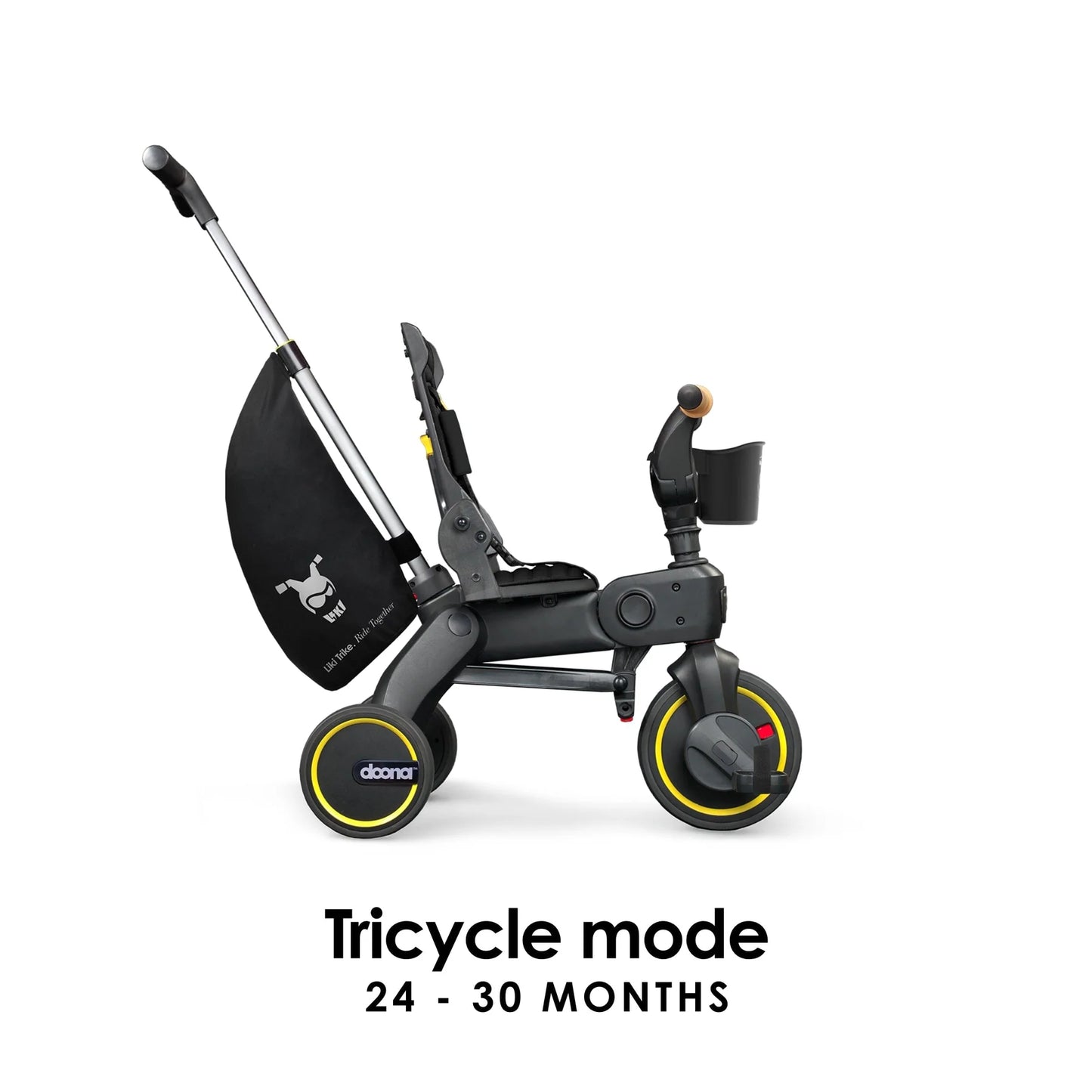Doona Liki Trike S5 in Midnight Black shown in full tricycle mode with pedals and handlebar engaged — perfect for toddlers gaining independence, available from Thursday’s Child Rental.