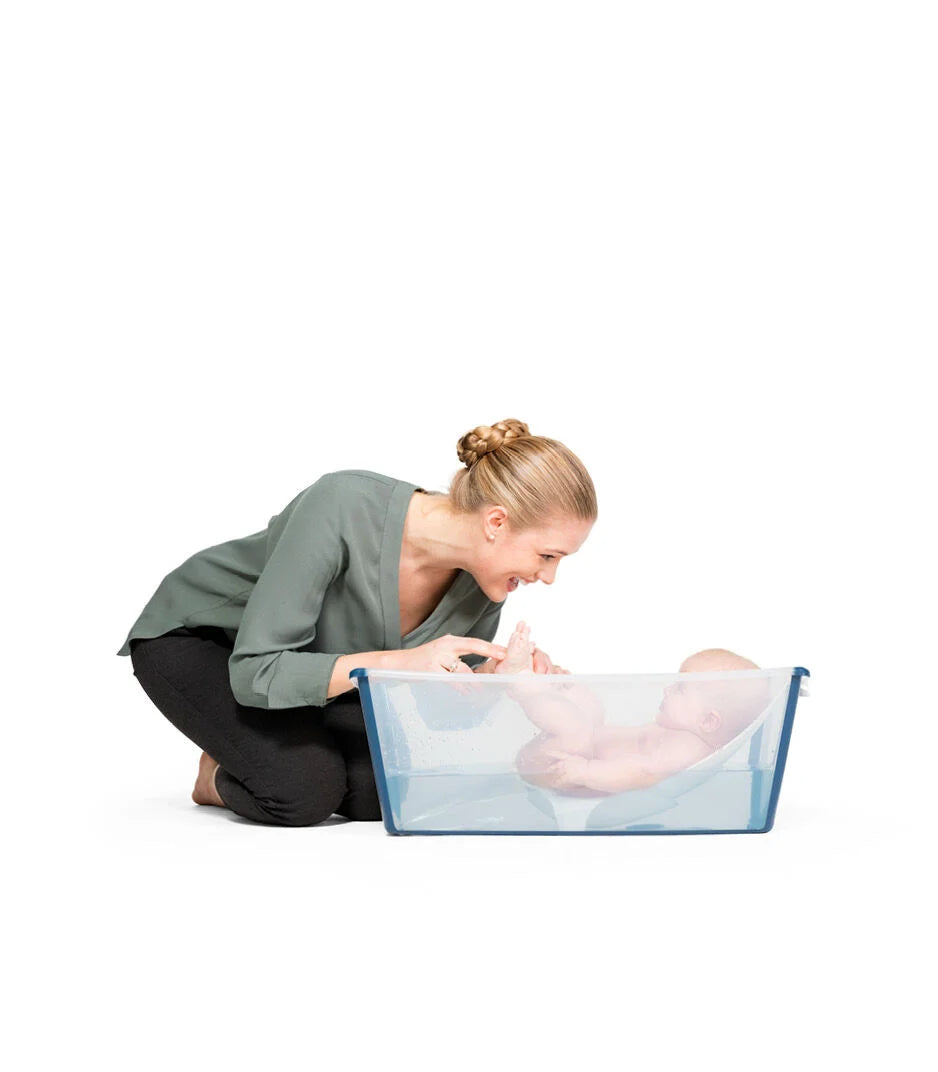 Stokke Flexi Bath with baby model – Comfortable, secure bathing solution for infants, available through Thursday’s Child Rental.