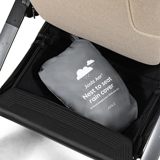 Joolz Aer+ Nest to Seat Raincover available from Thursday’s Child Rental, shown in use on stroller. Easy-fit transparent cover offering full rain protection for nest and seat modes.