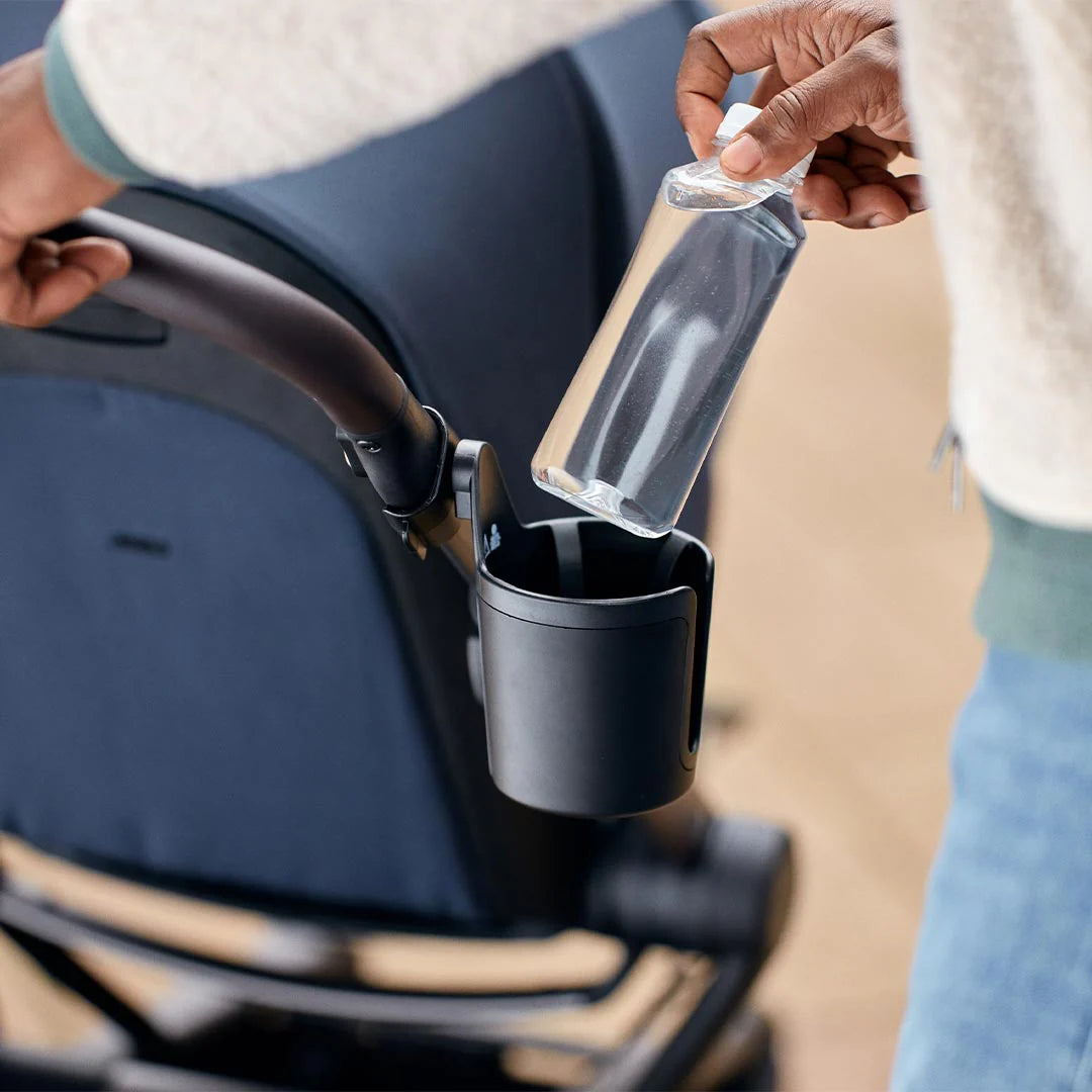 Reusable bottle in Joolz Aer Cup Holder during walk – part of Thursday’s Child Rental gear.