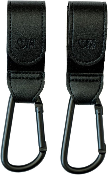 Two black straps with carabiners on a white background.
Black Harper & Me buggy clips attached to stroller handlebar – baby gear hire from Thursday’s Child Rental