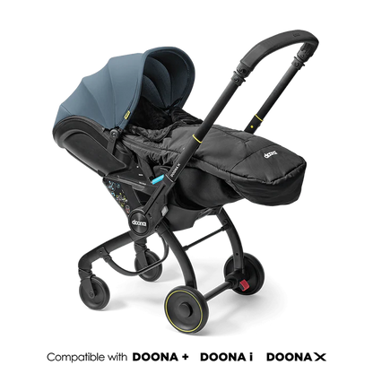 Doona Footmuff attached to stroller in sleek black design.