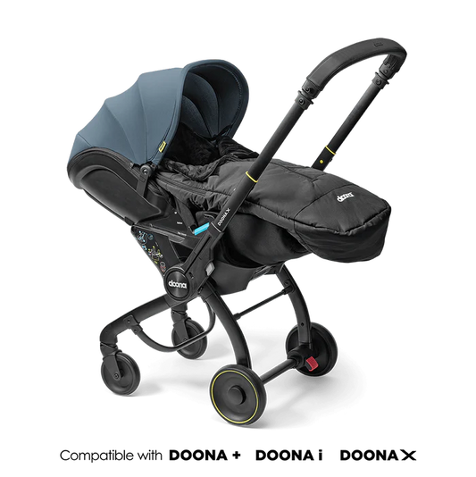 Doona Footmuff attached to stroller in sleek black design.