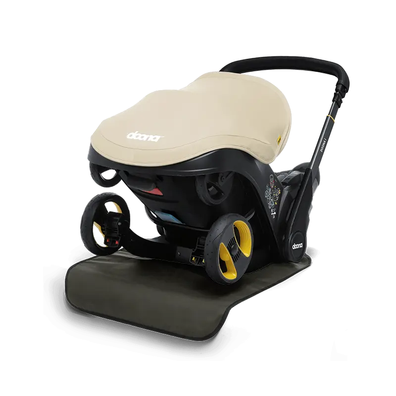 Doon Vehicle Seat Protector installed in car seat – waterproof, easy-to-clean cover for child car seat protection, available from Thursday’s Child Rental.