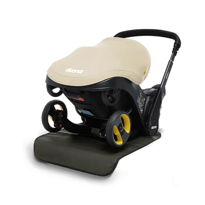 Doon Vehicle Seat Protector installed in car seat – waterproof, easy-to-clean cover for child car seat protection, available from Thursday’s Child Rental.