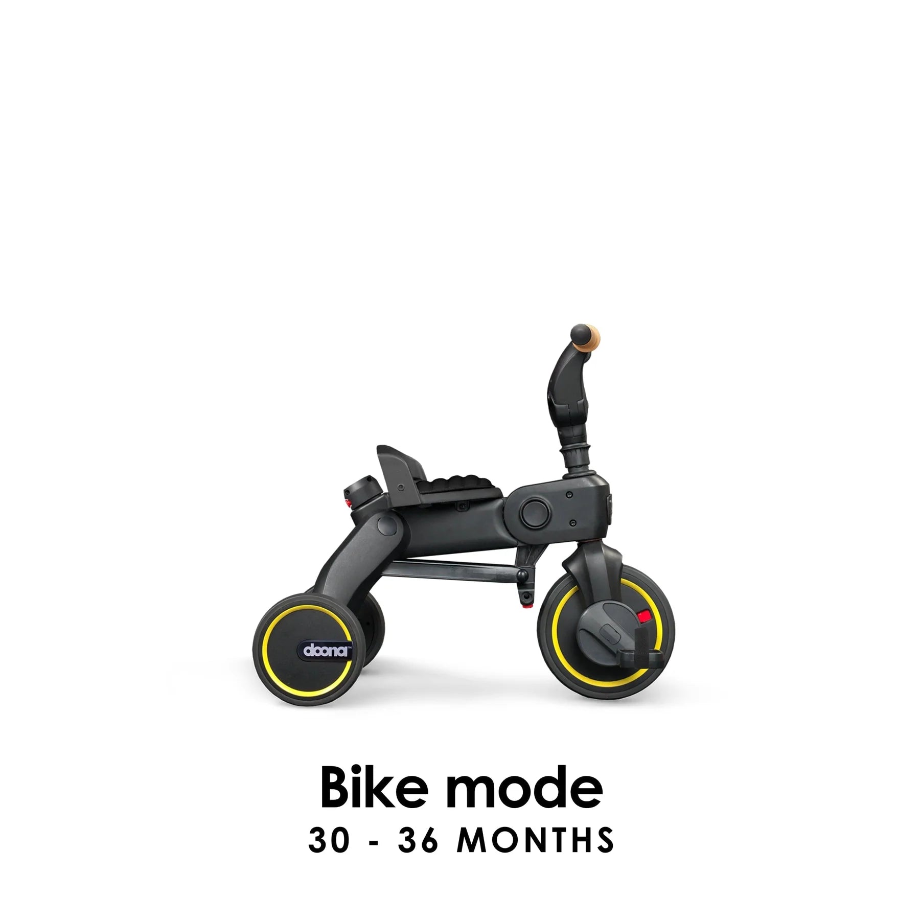 Doona Liki Trike S5 in Midnight Black shown in bike mode with pedals, handlebars, and backrest — ideal for toddler self-riding, available from Thursday’s Child Rental.
