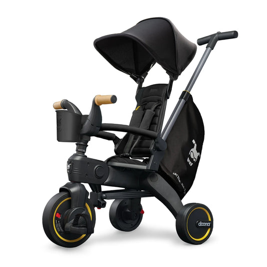 Doona Liki Trike S5 Midnight Edition – premium foldable trike in black with canopy and footrest, perfect for toddlers 10 months to 3 years, available at Thursday’s Child Rental.