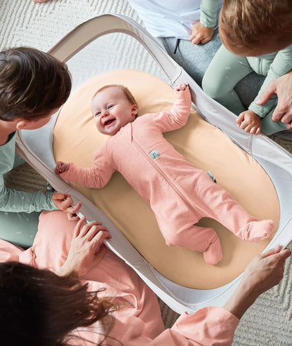 Baby resting inside breathable mesh Easy Sleep crib in light Ecru fabric.