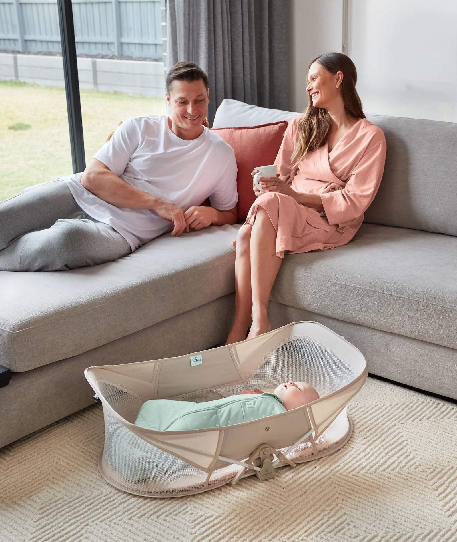 Toddler napping peacefully in travel-friendly Easy Sleep Crib with soft Ecru bedding.