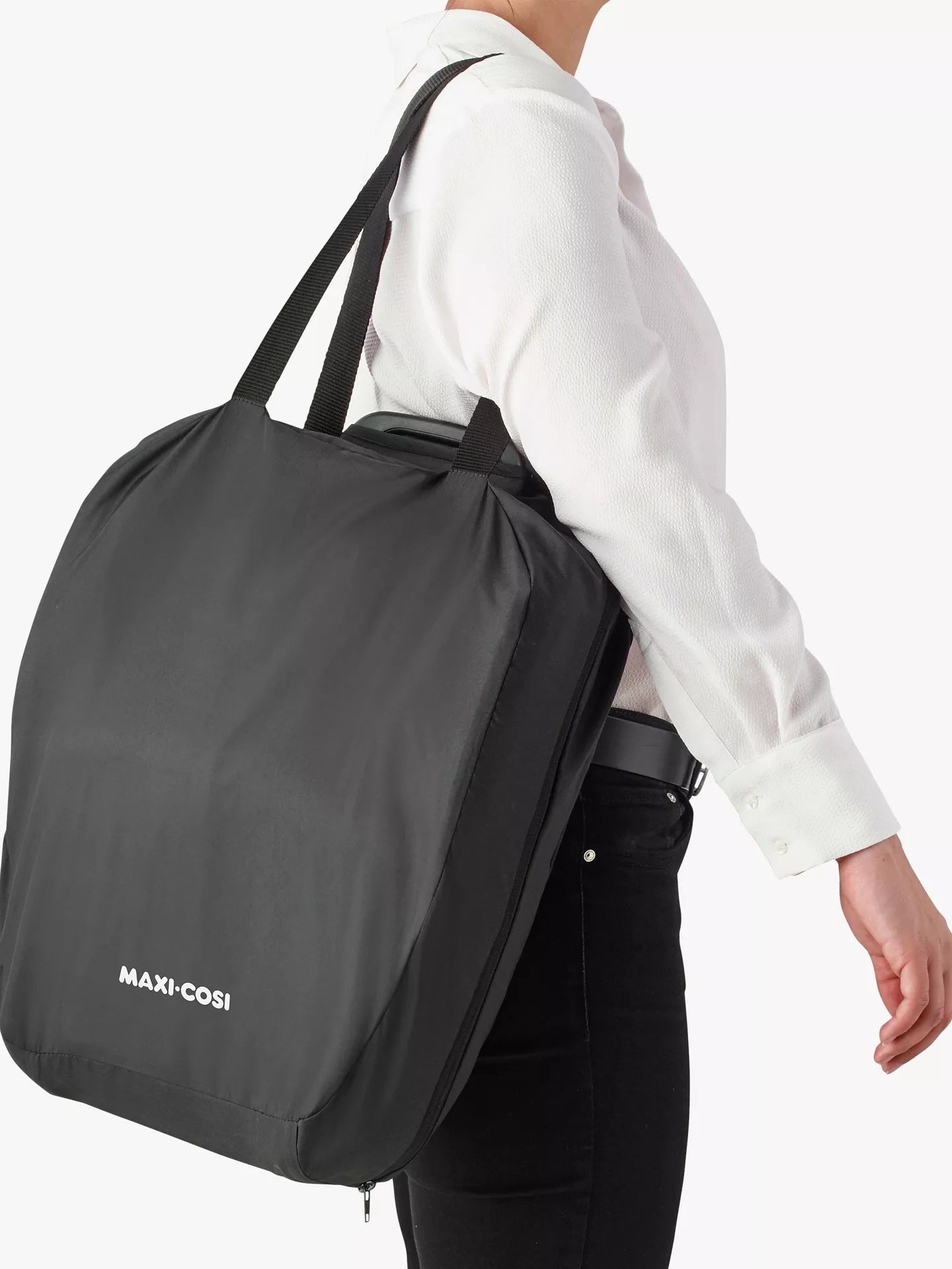 Parent carrying the Maxi-Cosi Nomad Plus in its lightweight carry bag – easy travel solution from Thursday's Child Rental.
