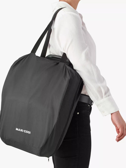 Parent carrying the Maxi-Cosi Nomad Plus in its lightweight carry bag – easy travel solution from Thursday's Child Rental.