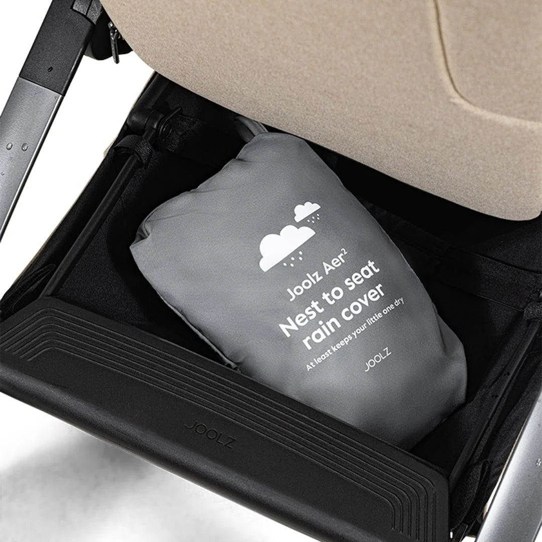 Joolz Aer+ Nest to Seat Raincover available from Thursday’s Child Rental, shown in use on stroller. Easy-fit transparent cover offering full rain protection for nest and seat modes.
